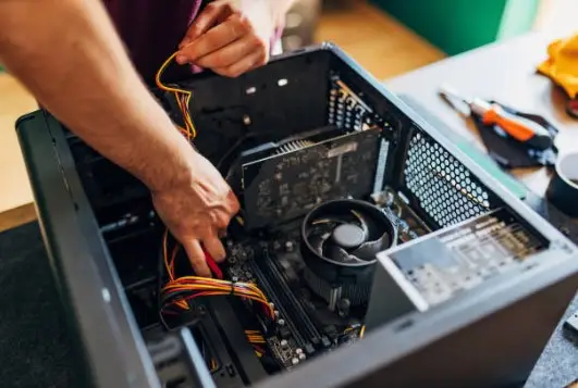 Person assembling computer components inside case
