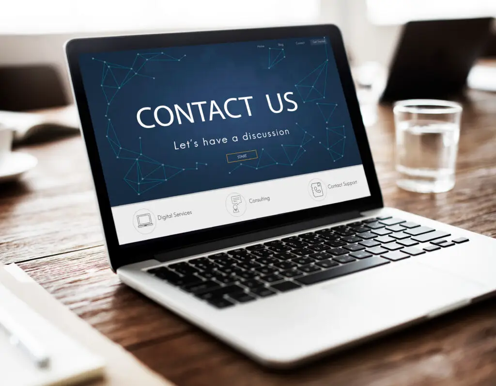 Laptop displaying contact information webpage