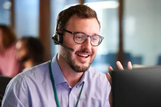 Person assisting with technical support.